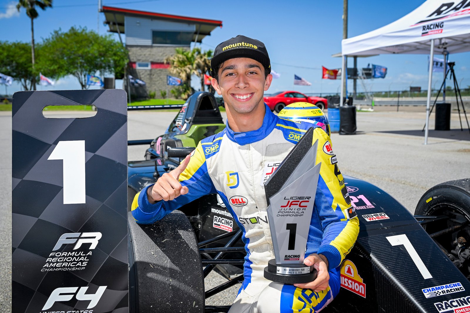 Race Development coach Beckham Jacir beside his formula racing car